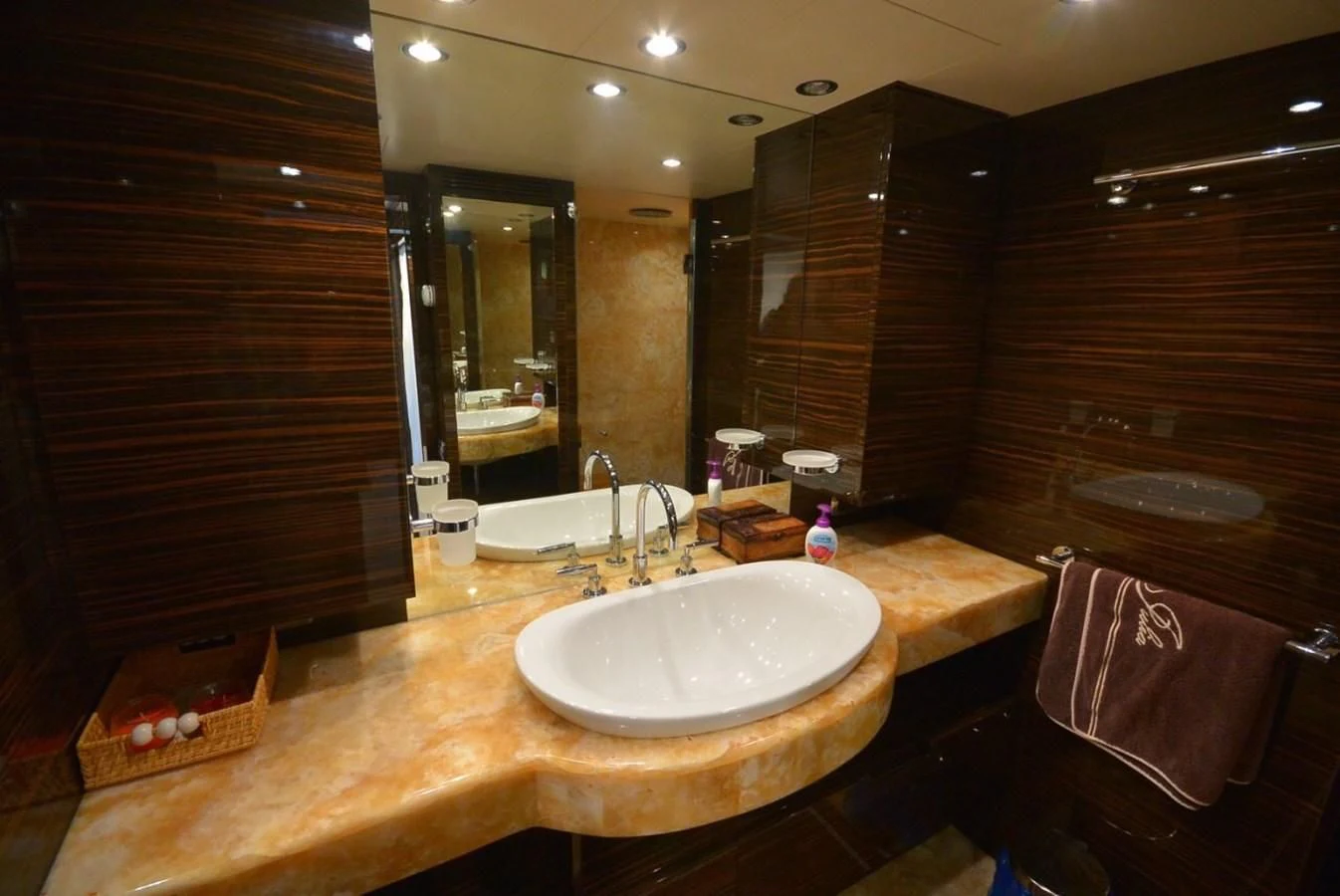 a bathroom with a countertop sink and a mirror aboard JULIA DOROTHY Yacht for Sale