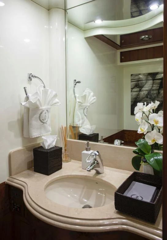 a bathroom with a sink and mirror aboard JULIA DOROTHY Yacht for Sale