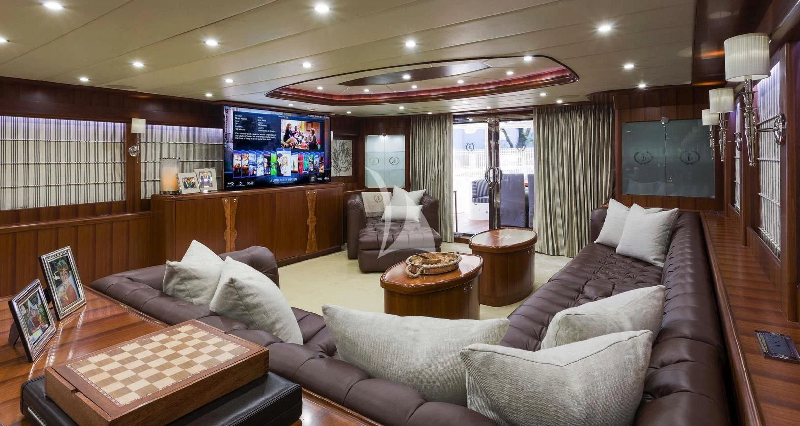 a living room with a large screen aboard JULIA DOROTHY Yacht for Sale