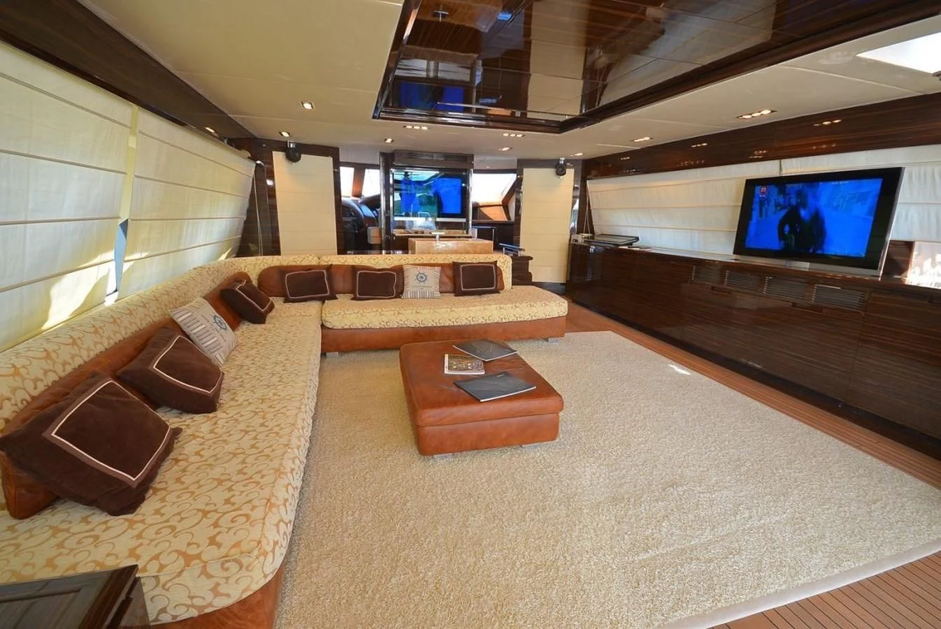 a large room with a tv and couches aboard JULIA DOROTHY Yacht for Sale