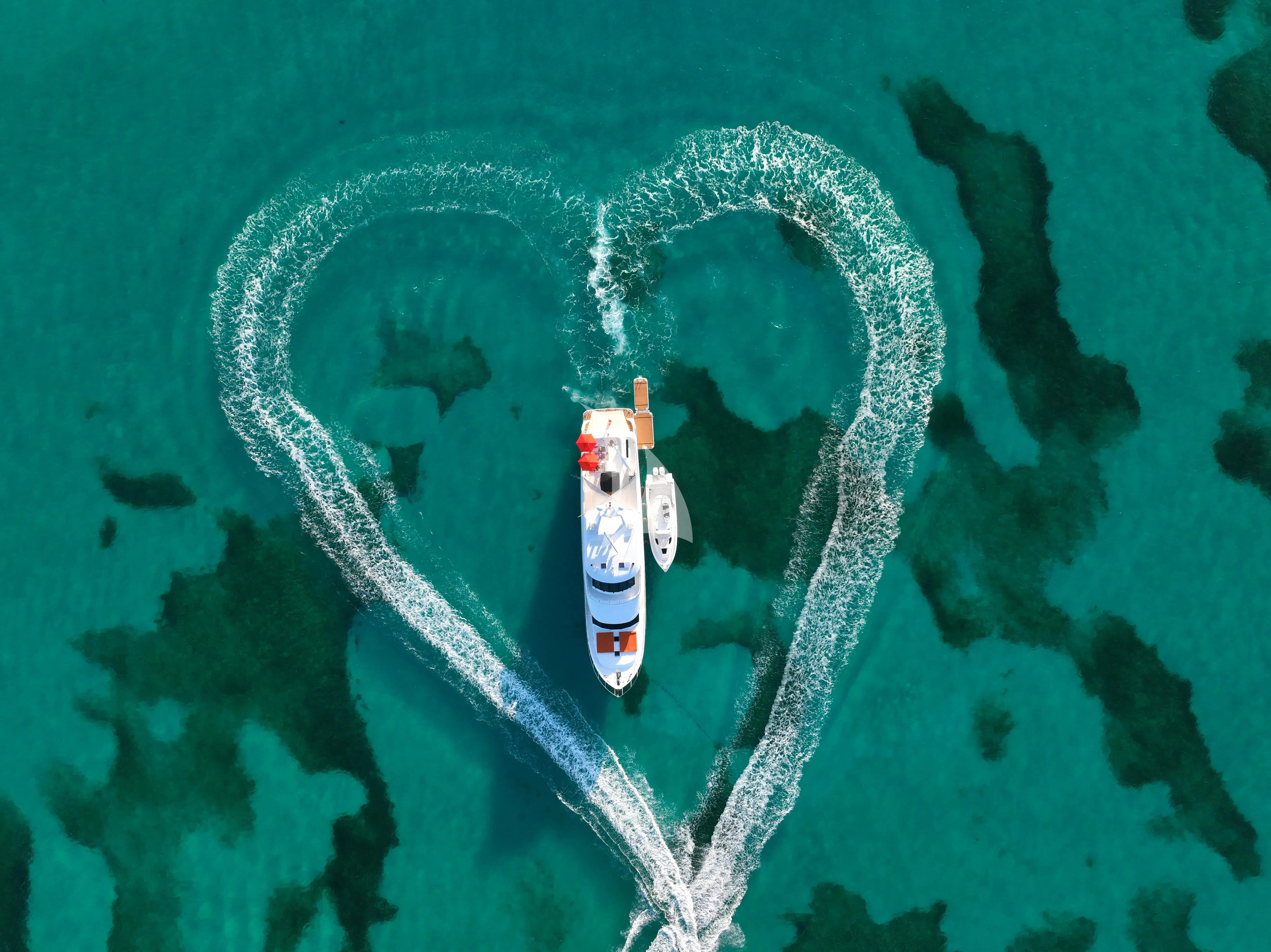 a small white boat in the water aboard JULIA DOROTHY Yacht for Sale