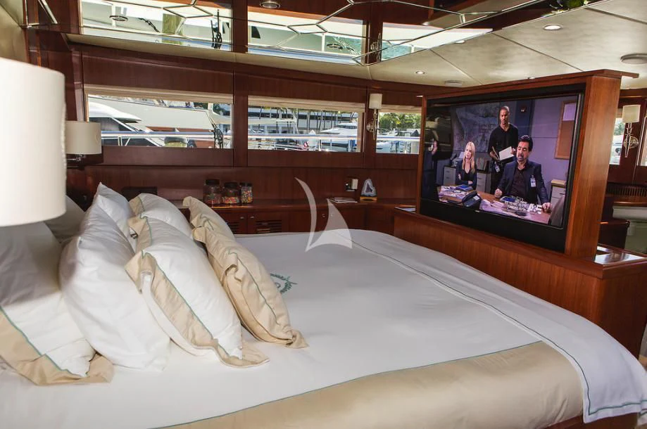 a bed with pillows and a television aboard JULIA DOROTHY Yacht for Sale