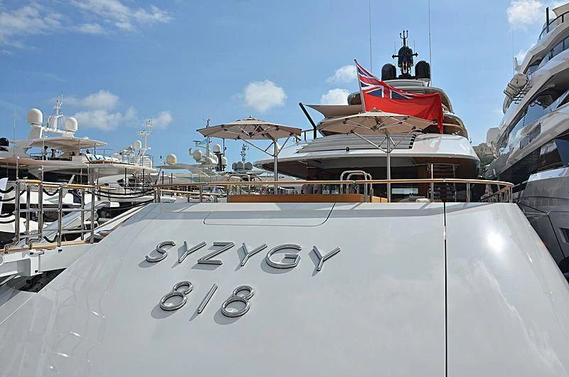 a boat with a flag on the front aboard 818 Yacht for Sale