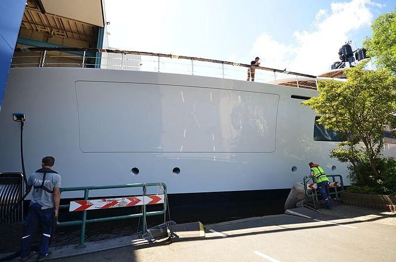 a group of men working on a large white building aboard 818 Yacht for Sale