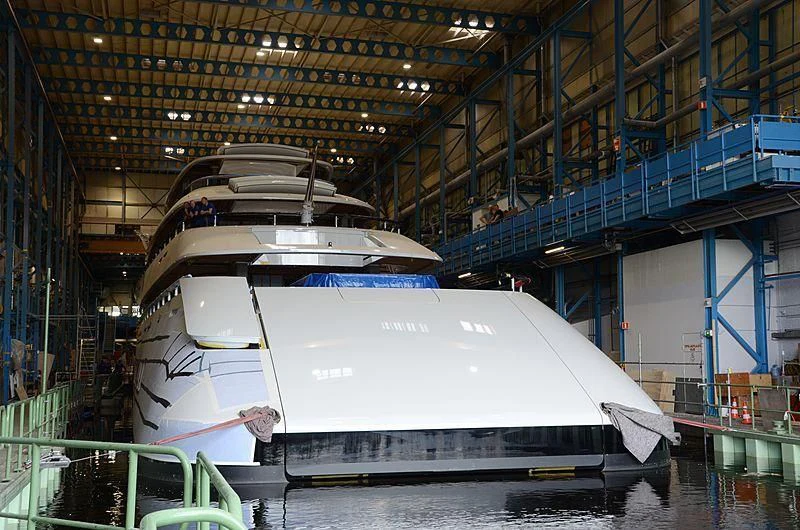 a large white ship in a large warehouse aboard 818 Yacht for Sale