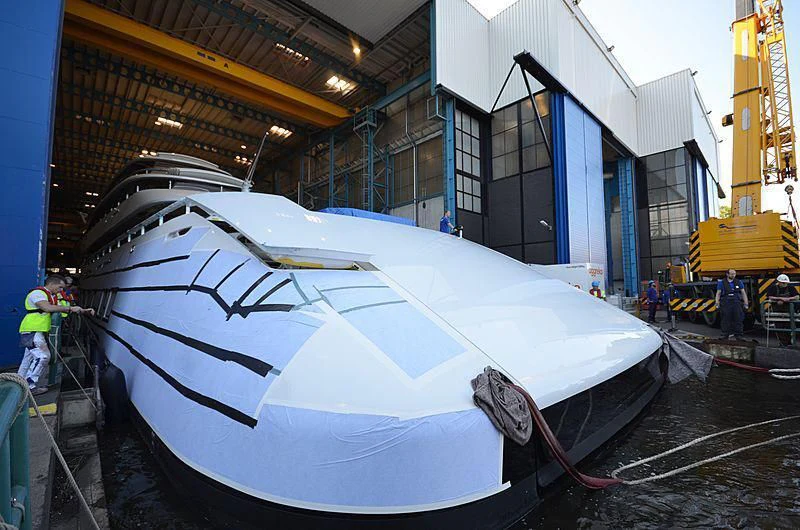 a large white boat in a factory aboard 818 Yacht for Sale