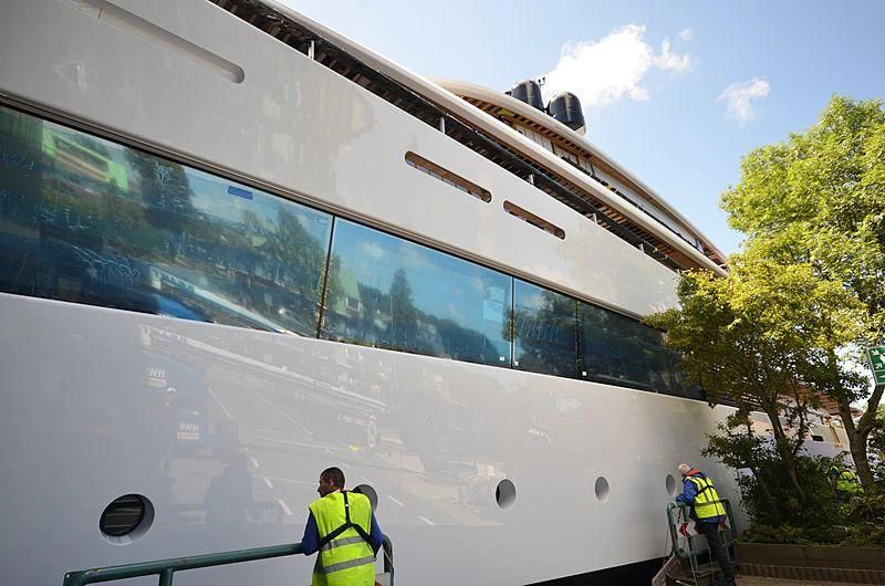 a large white bus with a couple of men standing next to it aboard 818 Yacht for Sale