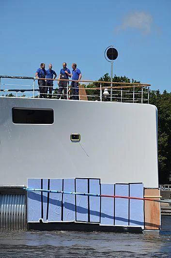 a group of people standing on a dock by a fence aboard 818 Yacht for Sale