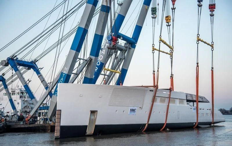 a large white boat with blue and red sails aboard 818 Yacht for Sale