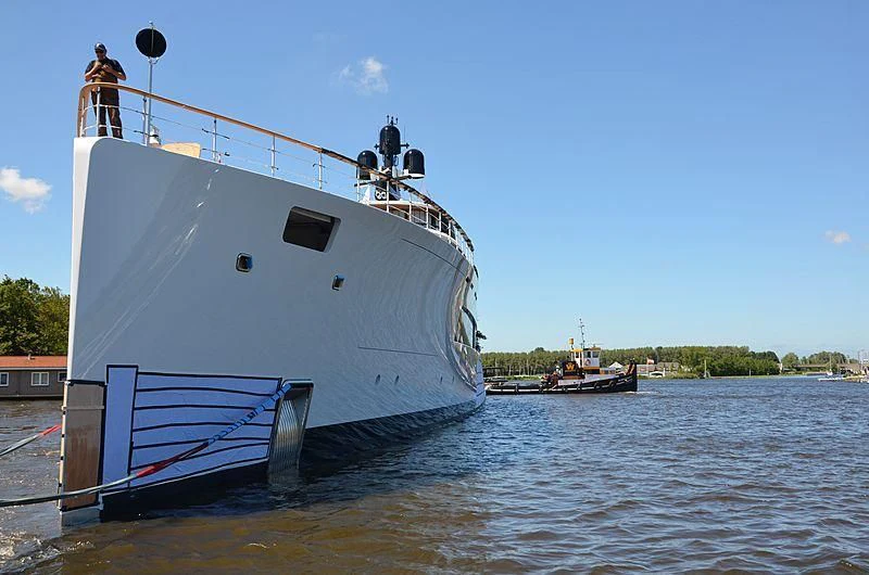 a large white boat with two men on it aboard 818 Yacht for Sale