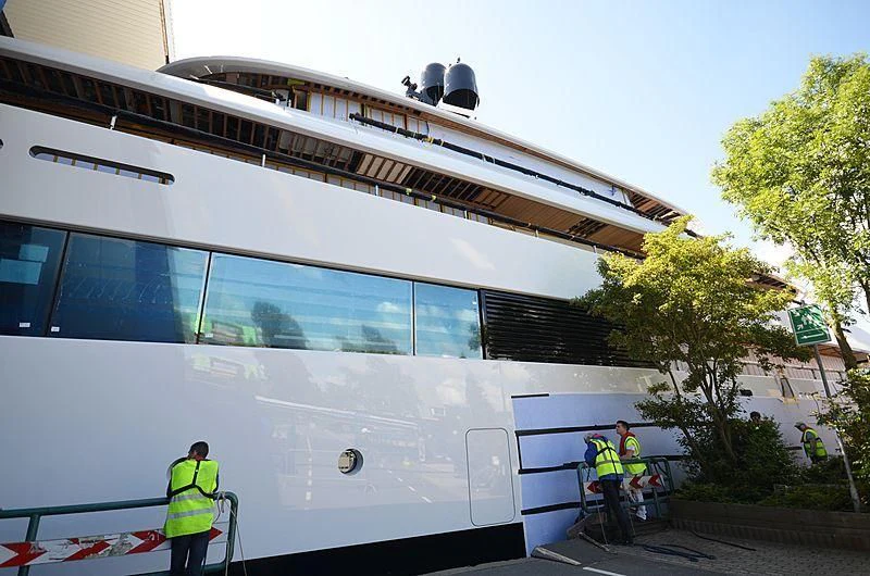 a group of people standing outside a large white bus aboard 818 Yacht for Sale