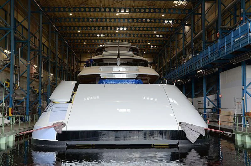 a white boat in a warehouse aboard 818 Yacht for Sale