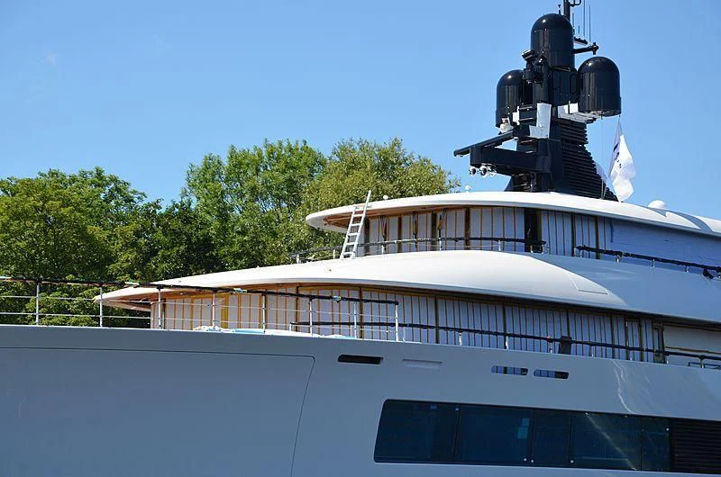 a large white boat with a black object on top aboard 818 Yacht for Sale