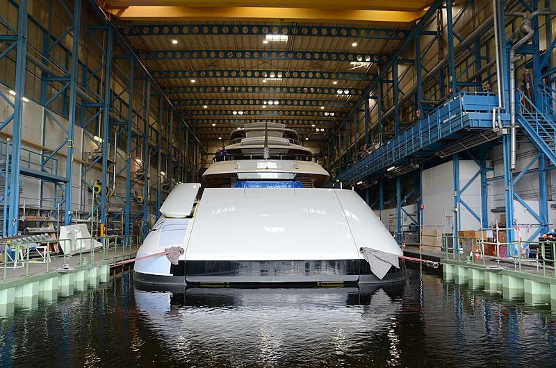a large white boat in a large warehouse aboard 818 Yacht for Sale