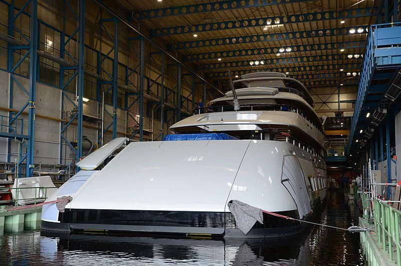 a large white boat in a warehouse aboard 818 Yacht for Sale