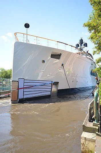 a large white boat with a metal frame on a dock aboard 818 Yacht for Sale