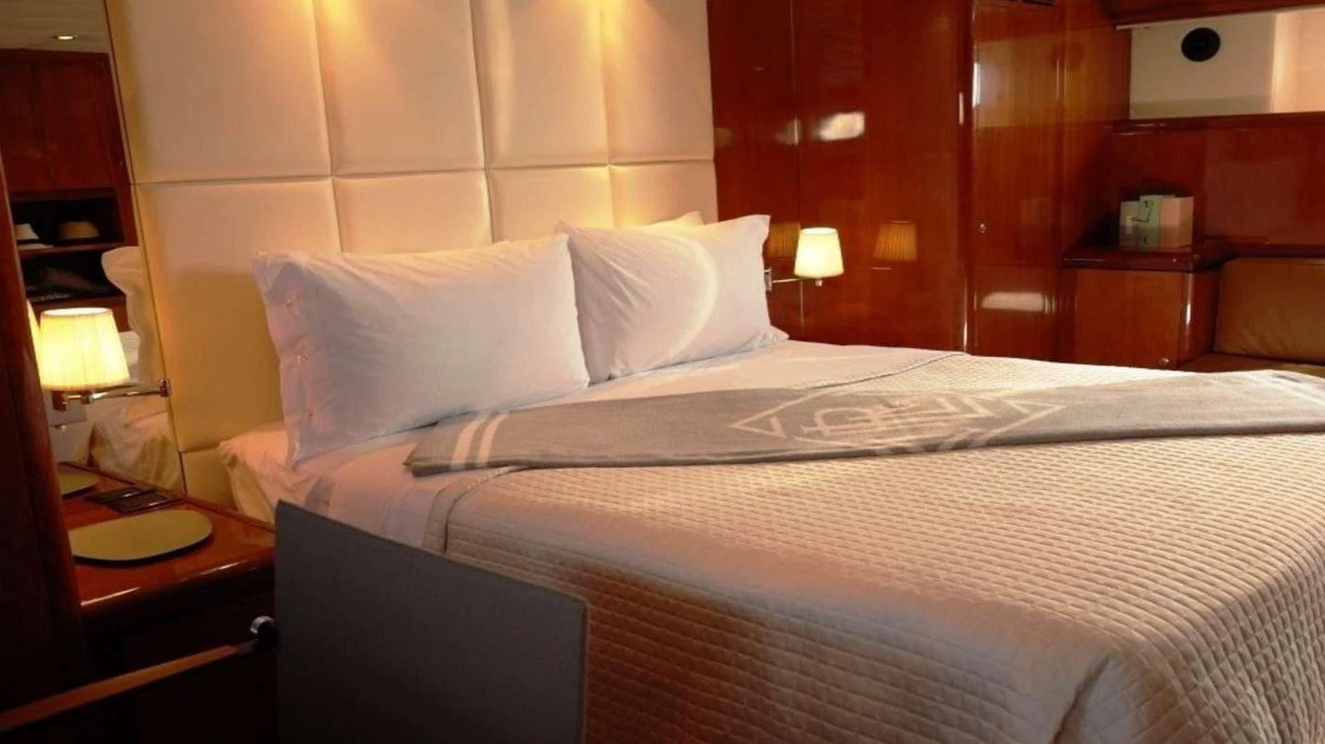 a bed with white sheets aboard MOONRAKER II Yacht for Sale