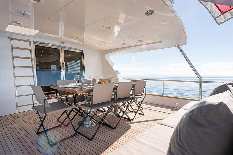 a room with a table and chairs aboard MOONRAKER II Yacht for Sale