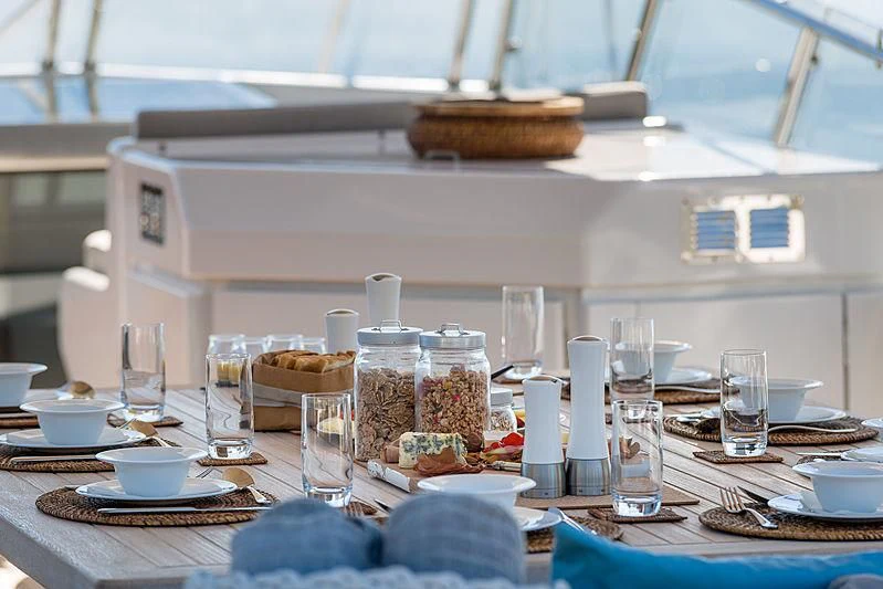a table with plates and glasses aboard MOONRAKER II Yacht for Sale