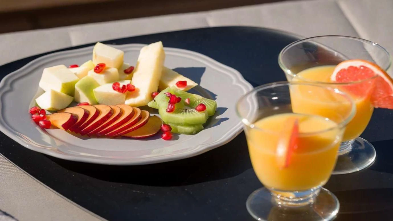 a plate of fruit and juice aboard MOONRAKER II Yacht for Sale