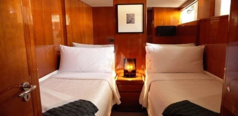 a room with two beds aboard MOONRAKER II Yacht for Sale