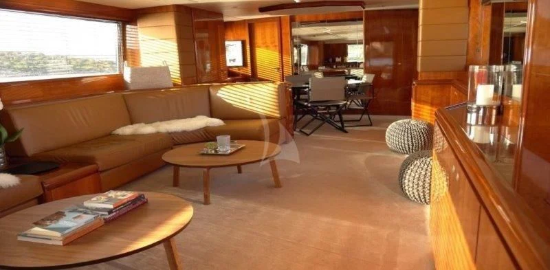 a living room with a couch and coffee table aboard MOONRAKER II Yacht for Sale