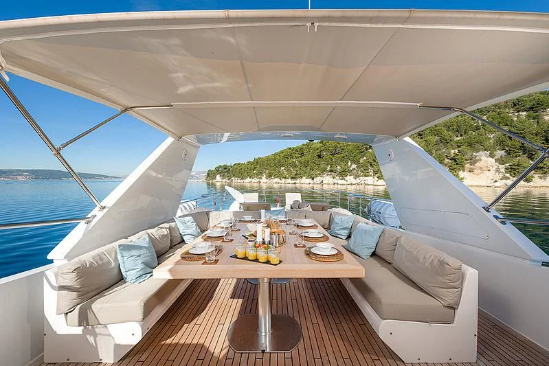 a room with a table and chairs aboard MOONRAKER II Yacht for Sale
