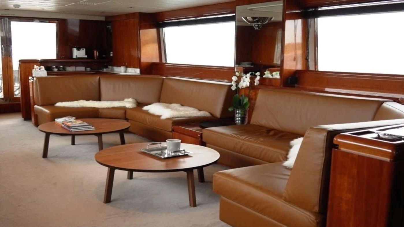 a living room with a couch and coffee table aboard MOONRAKER II Yacht for Sale
