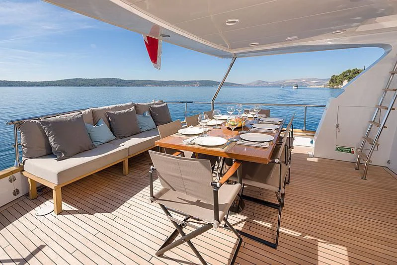 a table and chairs on a deck aboard MOONRAKER II Yacht for Sale