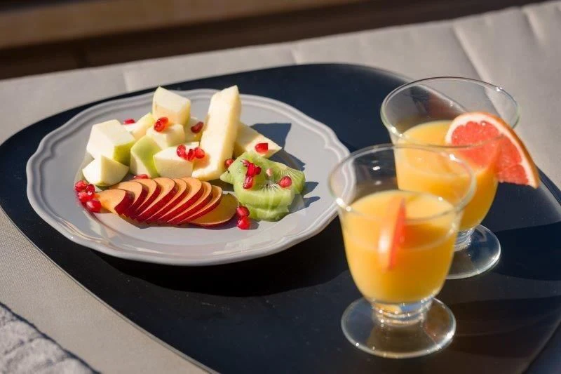 a plate of food and glasses of liquid on a table aboard MOONRAKER II Yacht for Sale