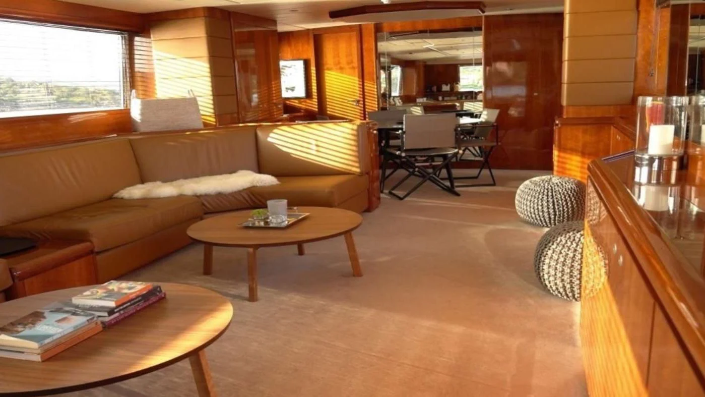 a living room with a couch and coffee table aboard MOONRAKER II Yacht for Sale