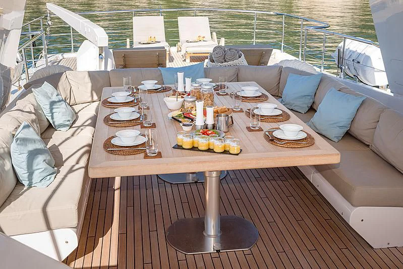 a table with plates and cups on it aboard MOONRAKER II Yacht for Sale