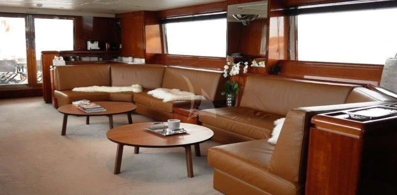 a living room with a couch and coffee table aboard MOONRAKER II Yacht for Sale