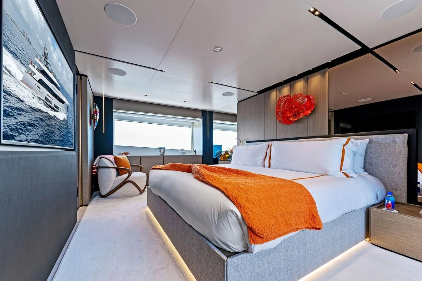 a bedroom with a bed and a desk aboard FAMILIA Yacht for Sale