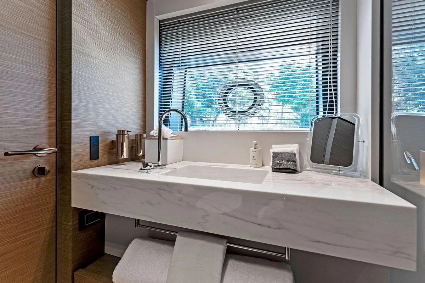 a bathroom with a sink and a television aboard FAMILIA Yacht for Sale