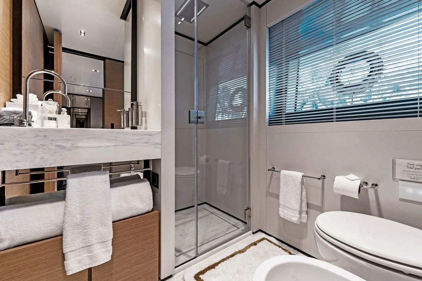 a bathroom with a glass shower aboard FAMILIA Yacht for Sale