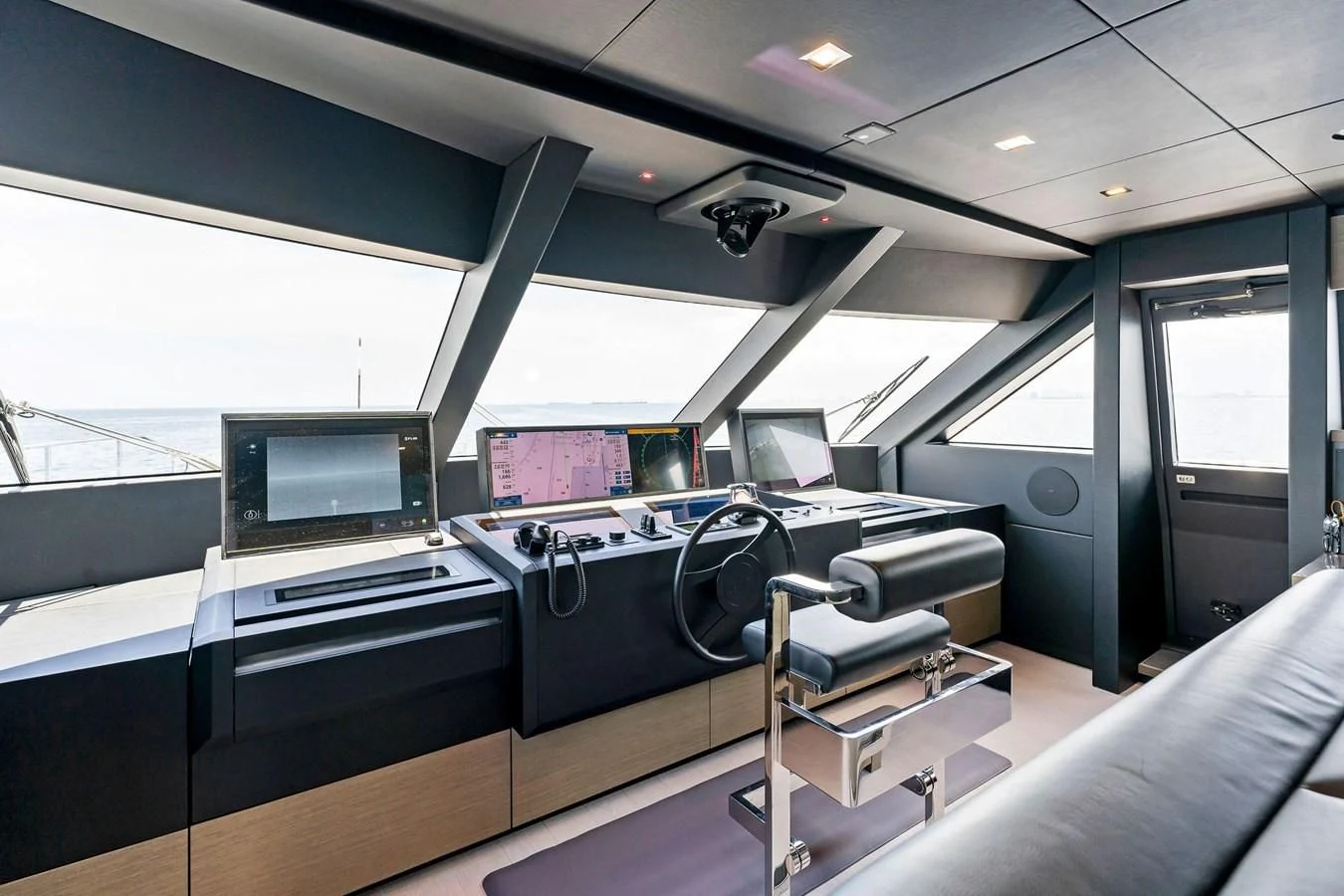 a room with a desk and chairs aboard FAMILIA Yacht for Sale