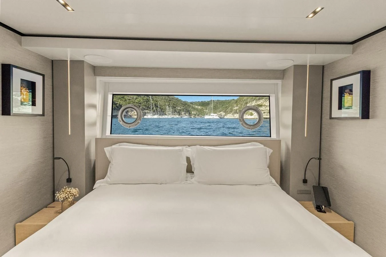 a bed with a large window aboard FAMILIA Yacht for Sale