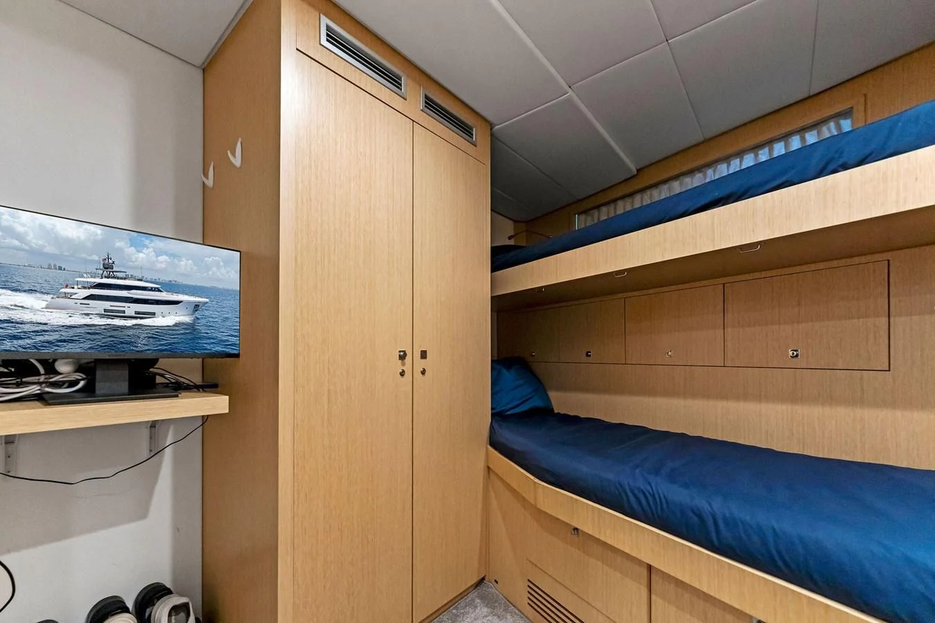 a room with a bed and a desk aboard FAMILIA Yacht for Sale