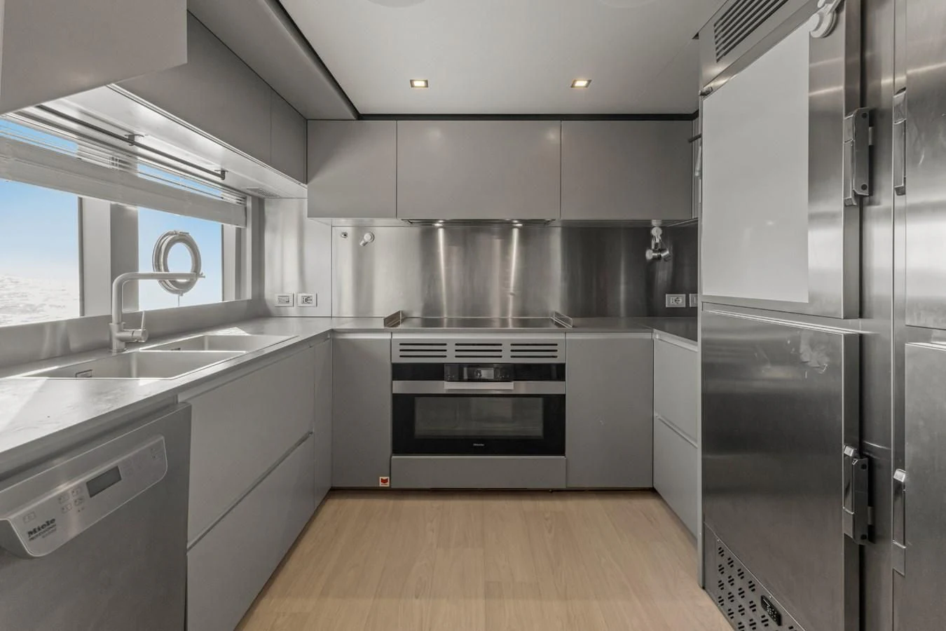 a kitchen with stainless steel appliances aboard FAMILIA Yacht for Sale