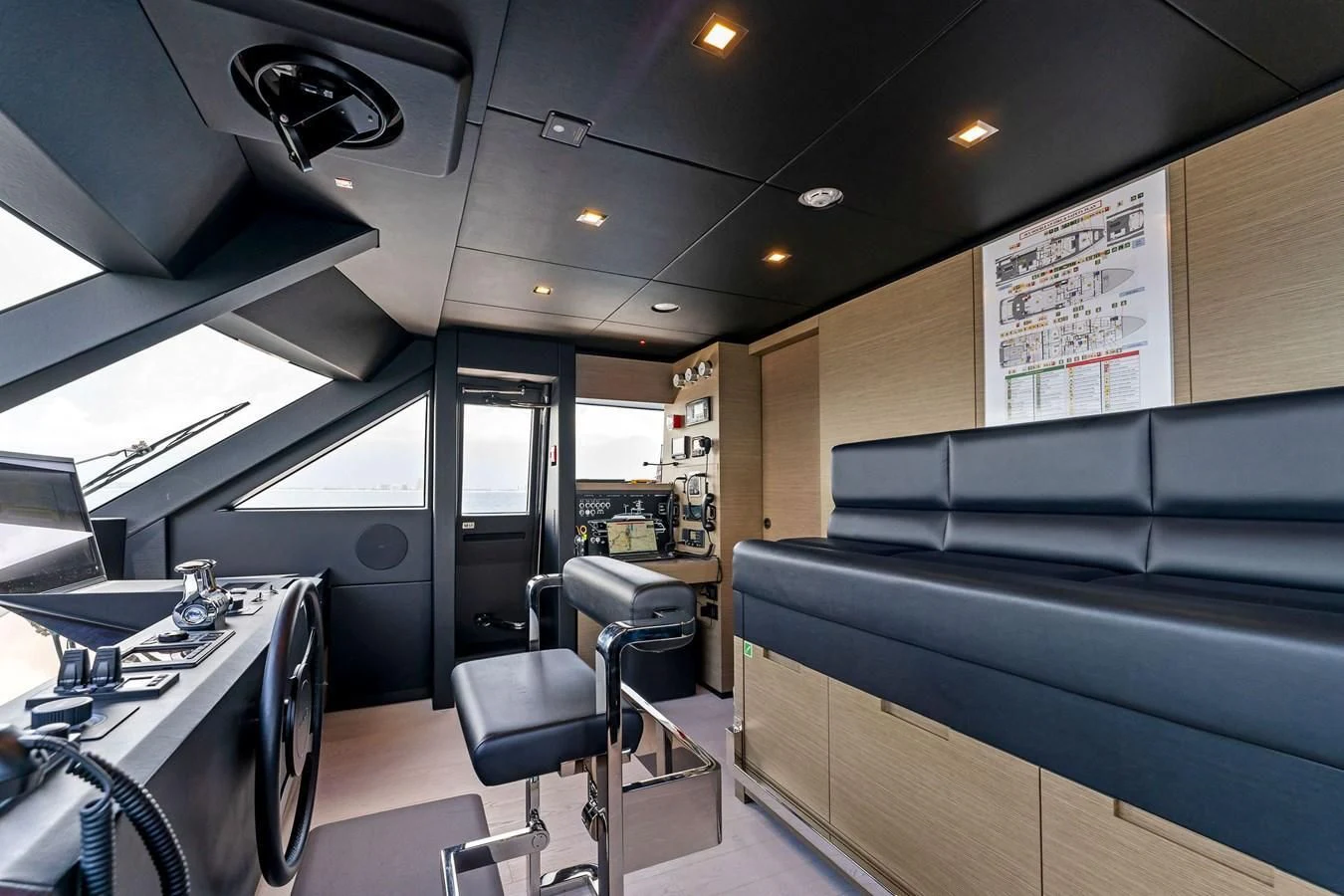 a room with a couch and a table and chairs aboard FAMILIA Yacht for Sale
