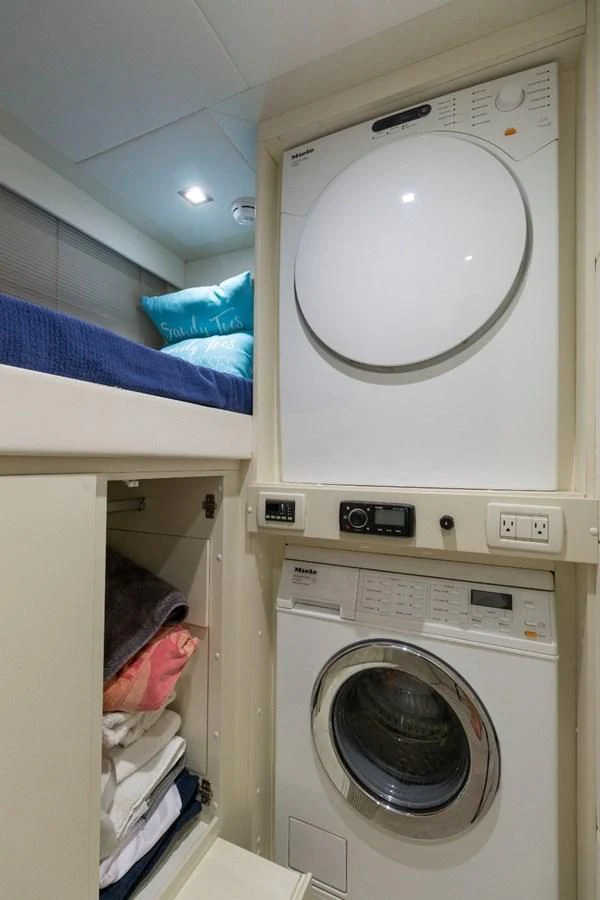 a person in a laundry room aboard SUGAR Yacht for Sale
