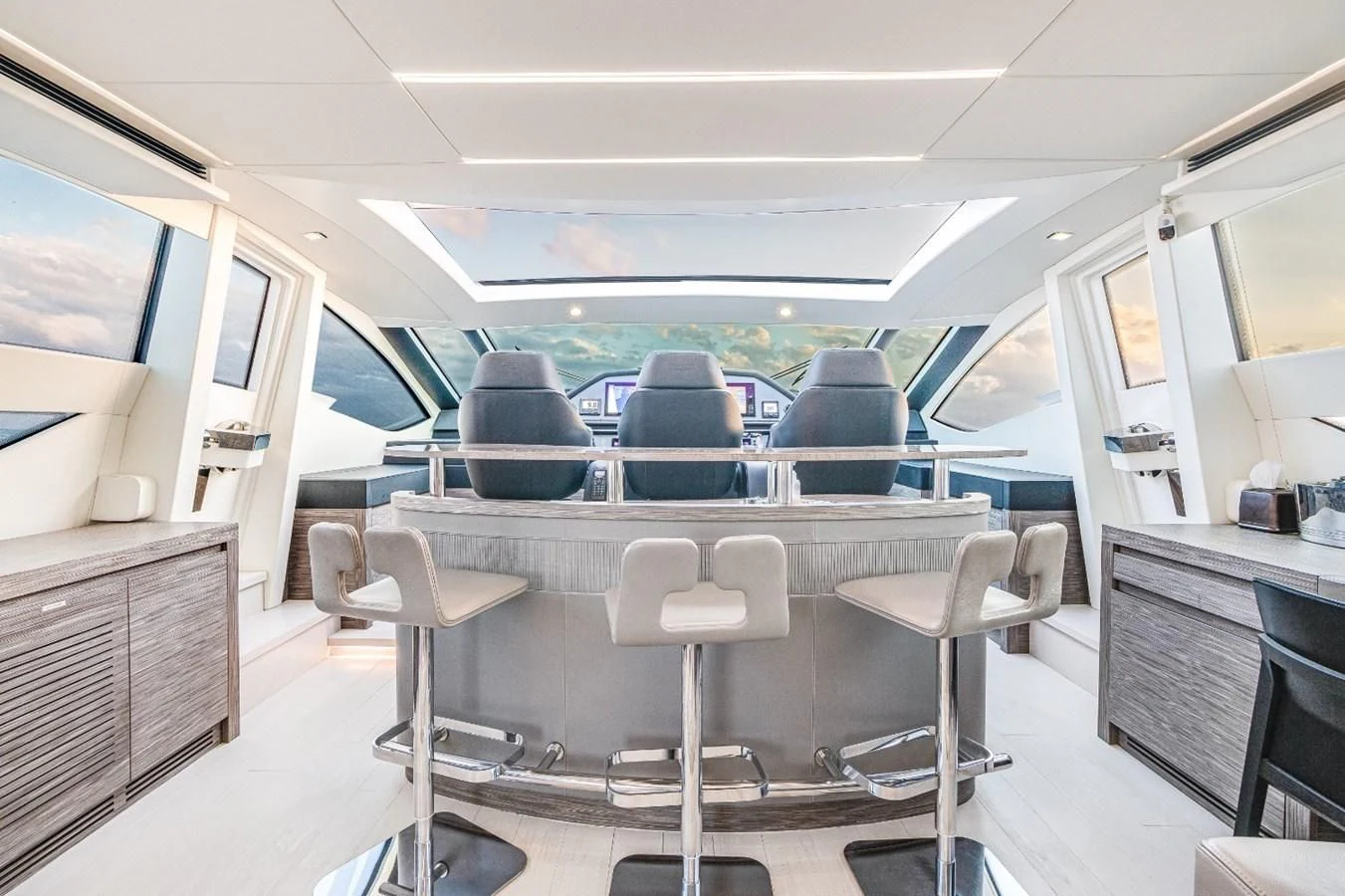 inside of a vehicle with chairs and tables and a television on the wall aboard SUGAR Yacht for Sale