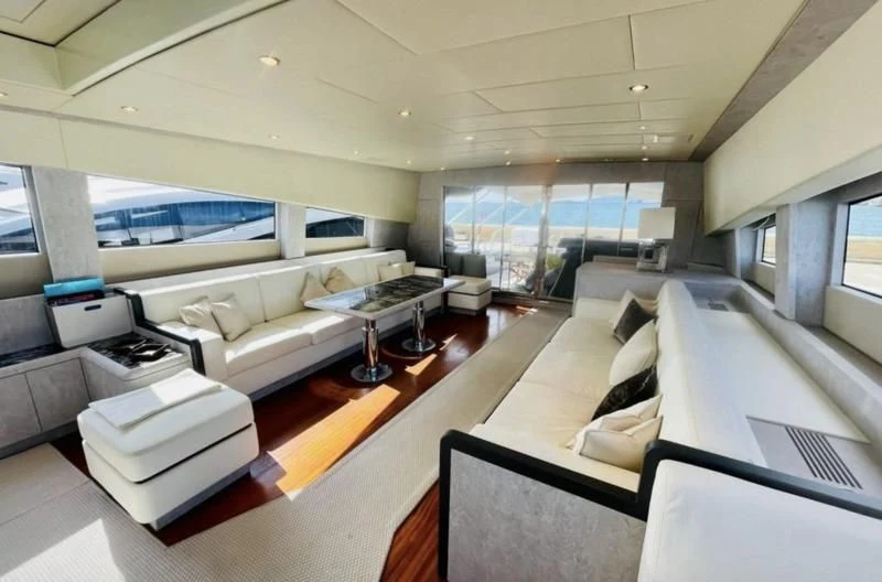 a room with a couch and a table aboard DARK KNIGHT Yacht for Sale