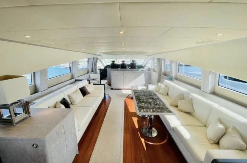 a room with a couch and a table aboard DARK KNIGHT Yacht for Sale