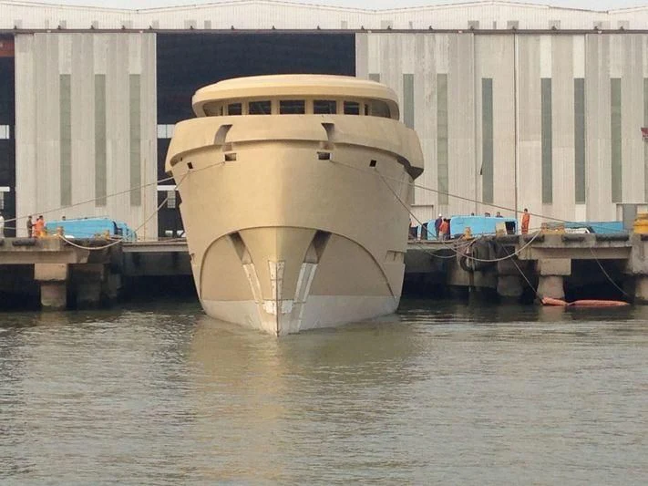 a large yellow boat in a harbor aboard GOLDEN ORCHID Yacht for Sale