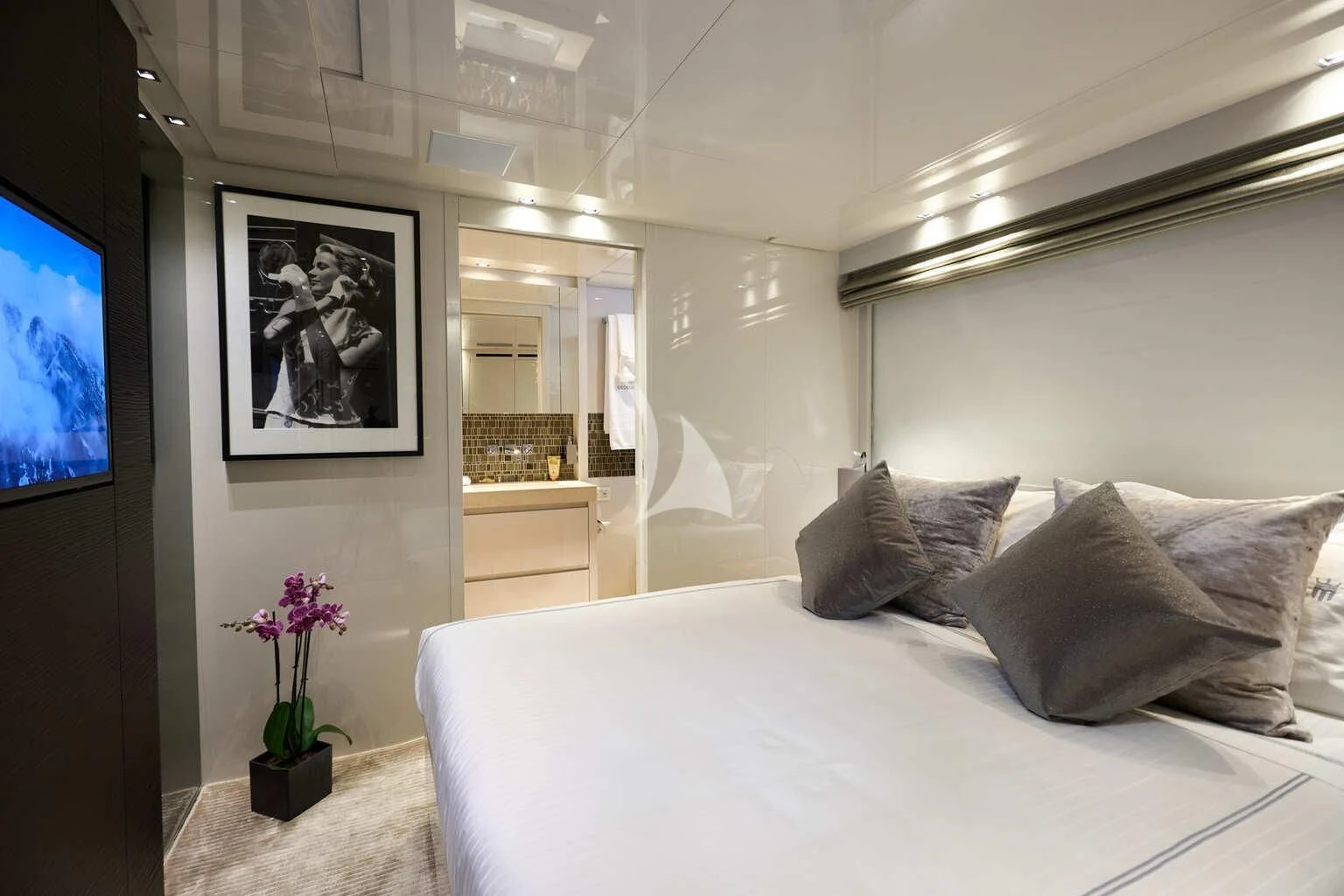 a bed with pillows and a television aboard DE ZEUS Yacht for Sale