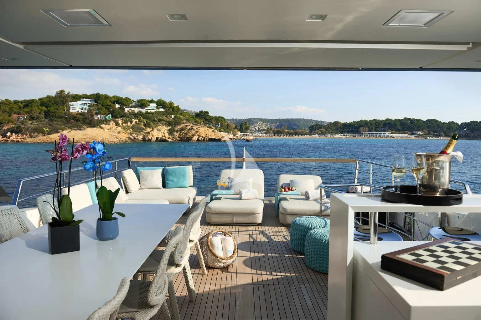 a room with a table chairs and a view of a city aboard DE ZEUS Yacht for Sale