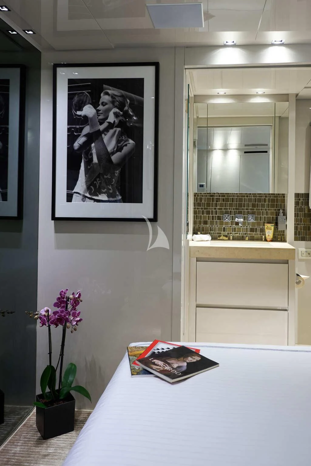 a white table with a book and flowers on it aboard DE ZEUS Yacht for Sale