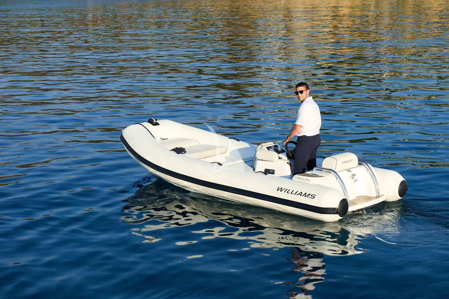 a man standing on a boat in the water aboard DE ZEUS Yacht for Sale